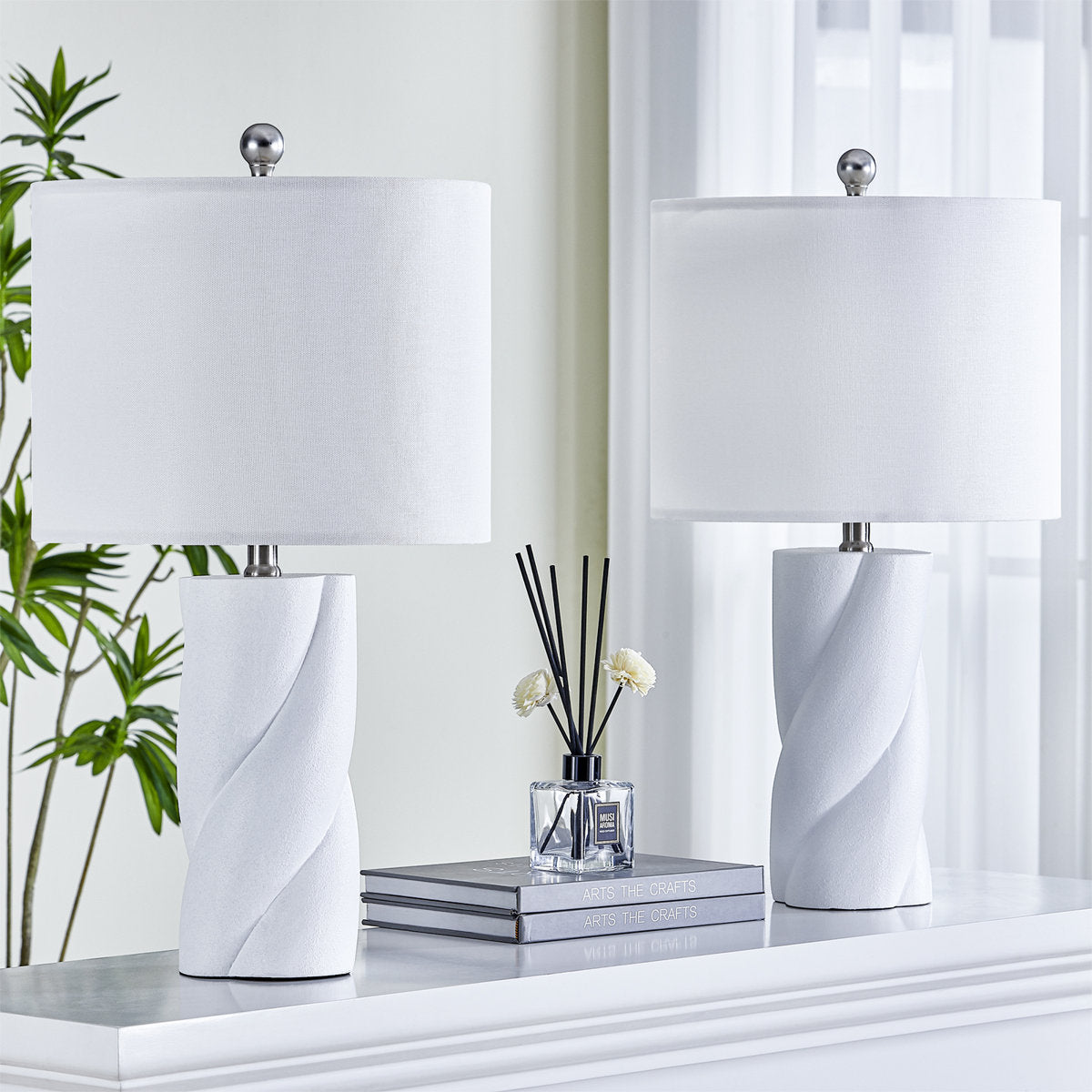 White Sculpted Ceramic Table Lamps — pair on a console with lights off