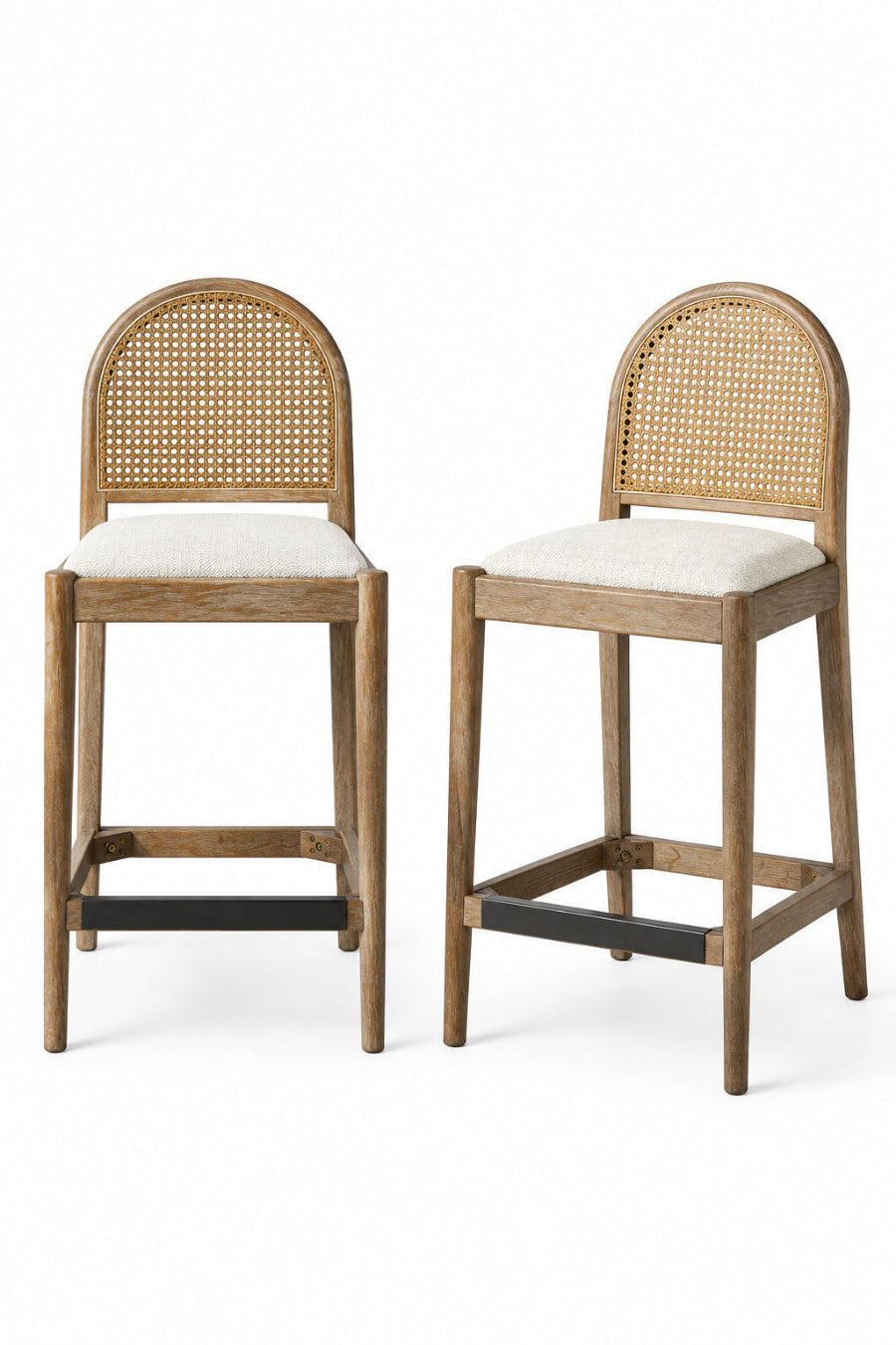 Two wooden bar stools with woven backrests in a kitchen setting.