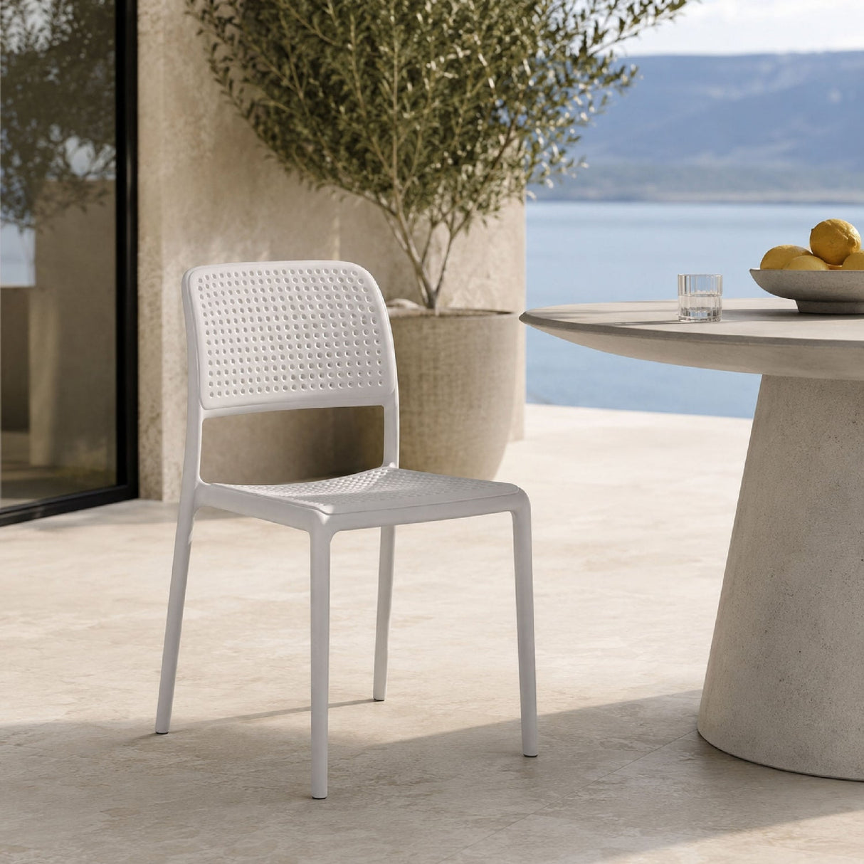 Perforated Fiberglass Outdoor Dining Chair – Bora – outdoor angled view