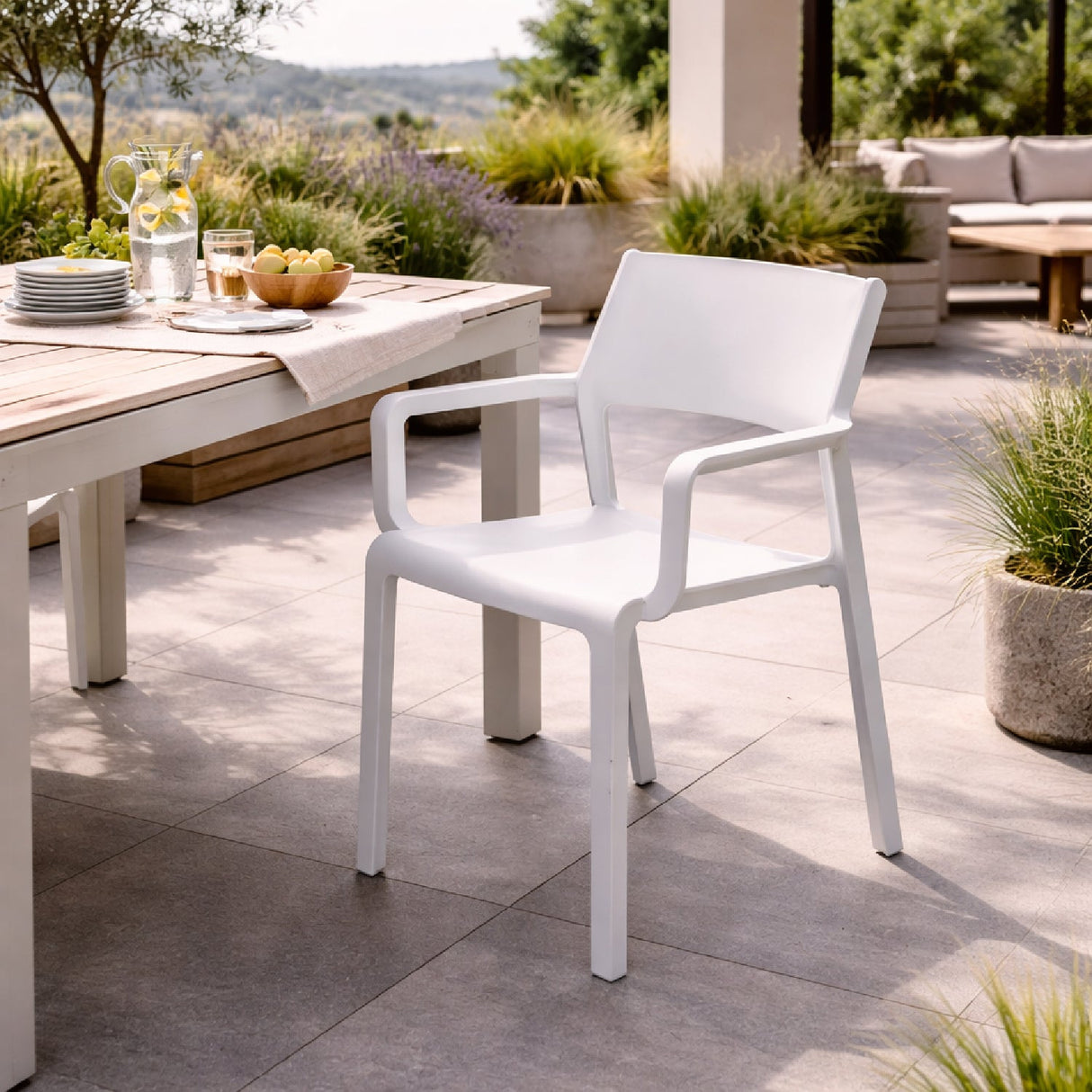 Open-back Outdoor Dining Armchair – Trill – outdoor angled view