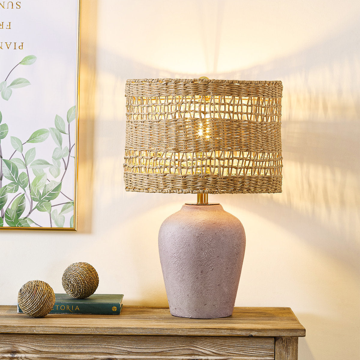 Antique Gray Ceramic Table Lamp with Rattan Shade — lit on a console