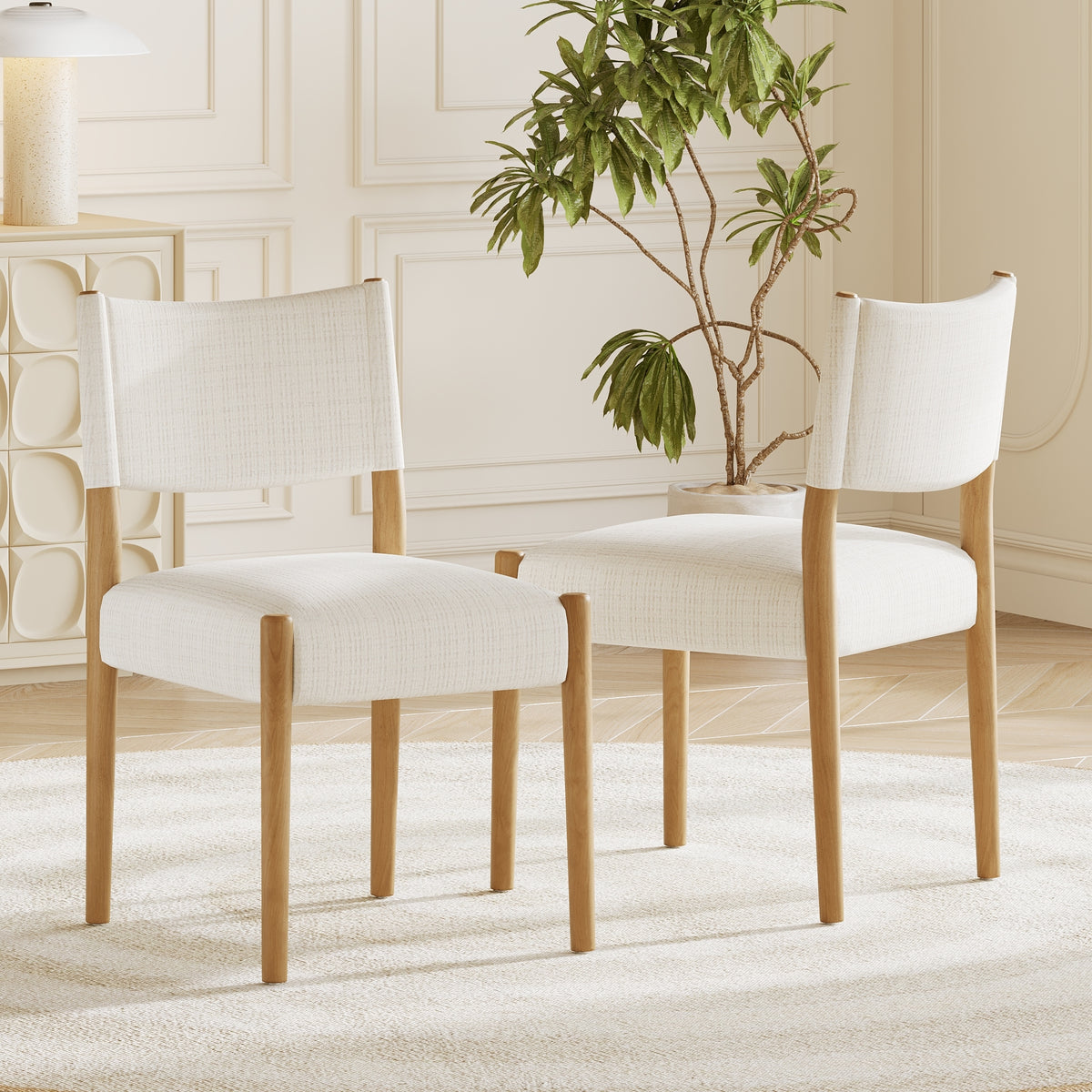 Cream Upholstered Natural Wood Dining Chairs — beside a dining table