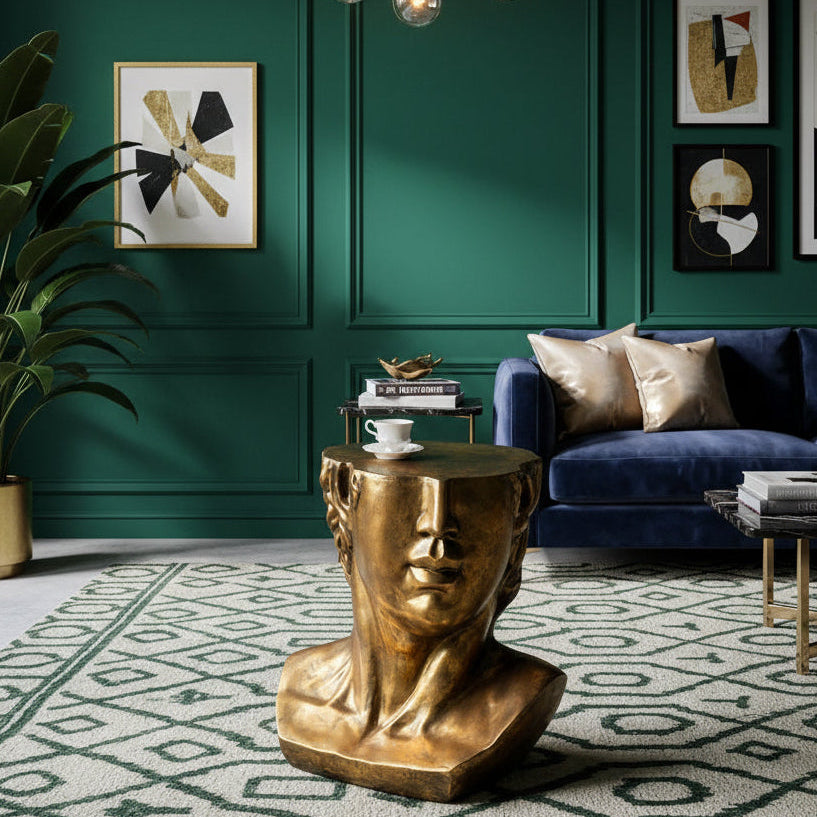 A decorative gold bust-shaped side table with a sculpted human face.