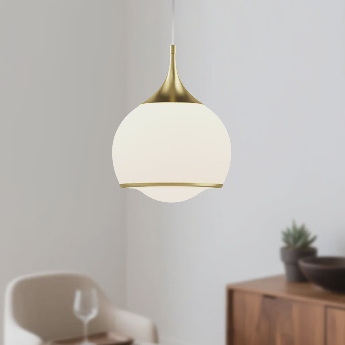 Gold Glass Integrated LED Pendant Light — lit against a neutral wall