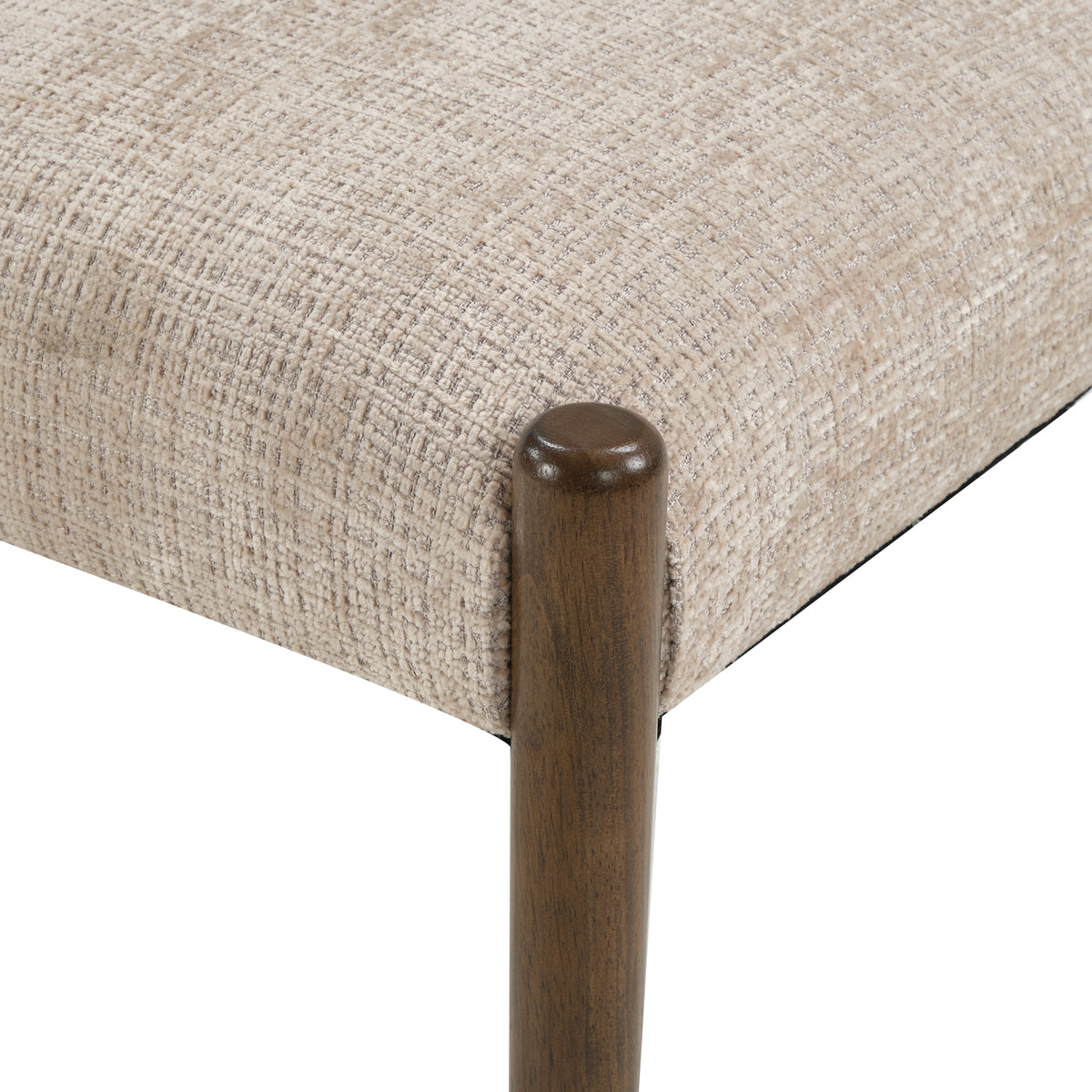 Upholstered dining chair with walnut-finish legs — seat cushion and leg close-up