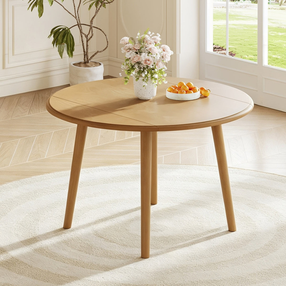 Natural Birch Veneer Round Drop-Leaf Dining Table — in a dining nook with leaves raised