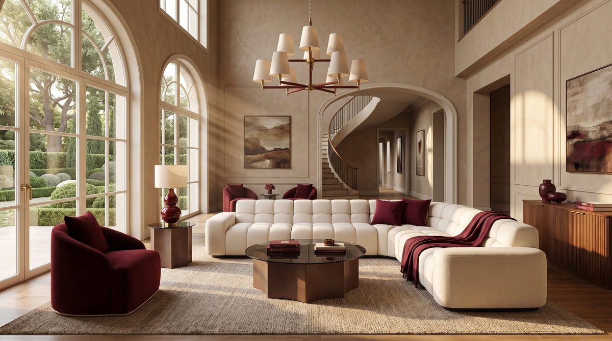 Living room featuring a deep burgundy accent chair, walnut furniture, cream upholstery and warm brass details, styled in a refined Fall 2026 palette by OROA.