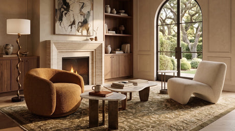 Reading corner featuring two distinct accent chairs, layered textures, and varied silhouettes, with OROA pieces shaping the seating arrangement.