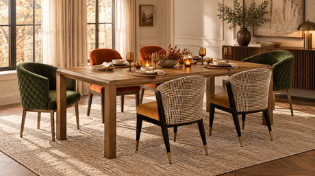 Elegant fall dining setting with a wooden table, velvet dining chairs and warm table accents