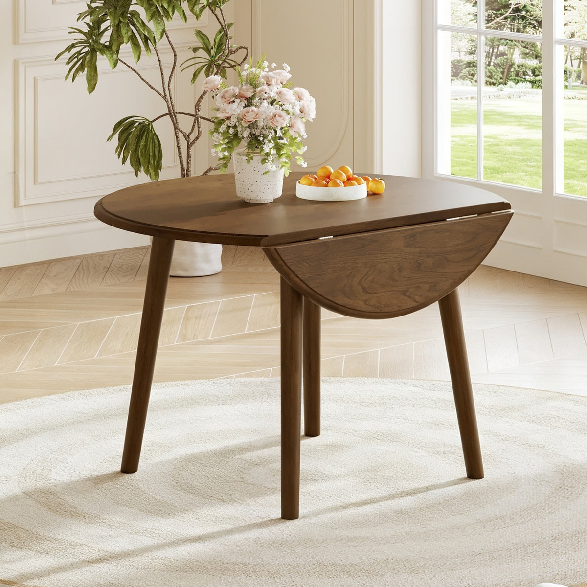 Walnut-Finish Birch Veneer Round Drop-Leaf Dining Table — in a dining nook with one leaf lowered