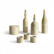 Set of stone-like bottles and cups on a white background