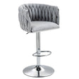 Gray tufted bar stool with chrome base on a white background