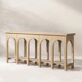 Natural Reclaimed Elm Console Table with Arched Base — against a living-room wall