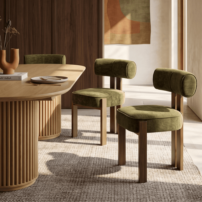 Soft upholstery, durable wood, and a modern metal frame define this OROA dining chair, styled within a warm minimalism dining room.
