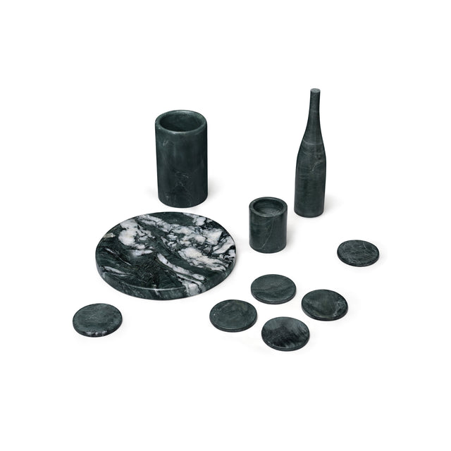 Set of black marble coasters and vases on a white background