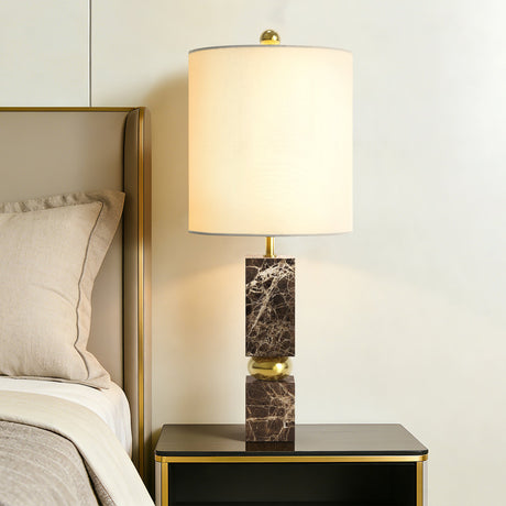 Brown Marble and Gold Metal Table Lamp — beside a bed