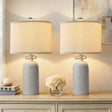 Gray Textured Ceramic Dimmable Table Lamps — lit pair on a console