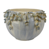Decorative ceramic planter with leaf design on a white background