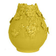 Yellow ceramic vase with floral designs on a white background