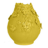 Yellow ceramic vase with floral designs on a white background