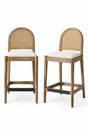Two wooden bar stools with woven backrests in a kitchen setting.