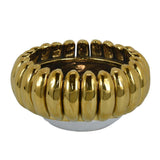 Classic form meets playful glamour in the Milly Decorative Bowl. Crafted from ceramic, its round silhouette is surrounded by glossy gold petal-like details that create a rich sculptural texture. Fill it with fruit or decorative objects, or display it alone as a striking centerpiece on a dining table, console, coffee table, or kitchen island.

Dimensions: 12.5" W × 12.5" D × 6" H
Material: Ceramic