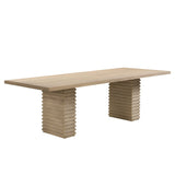 A modern rectangular dining table with a light natural wood top and two sculptural pedestal bases made of stacked wood slats