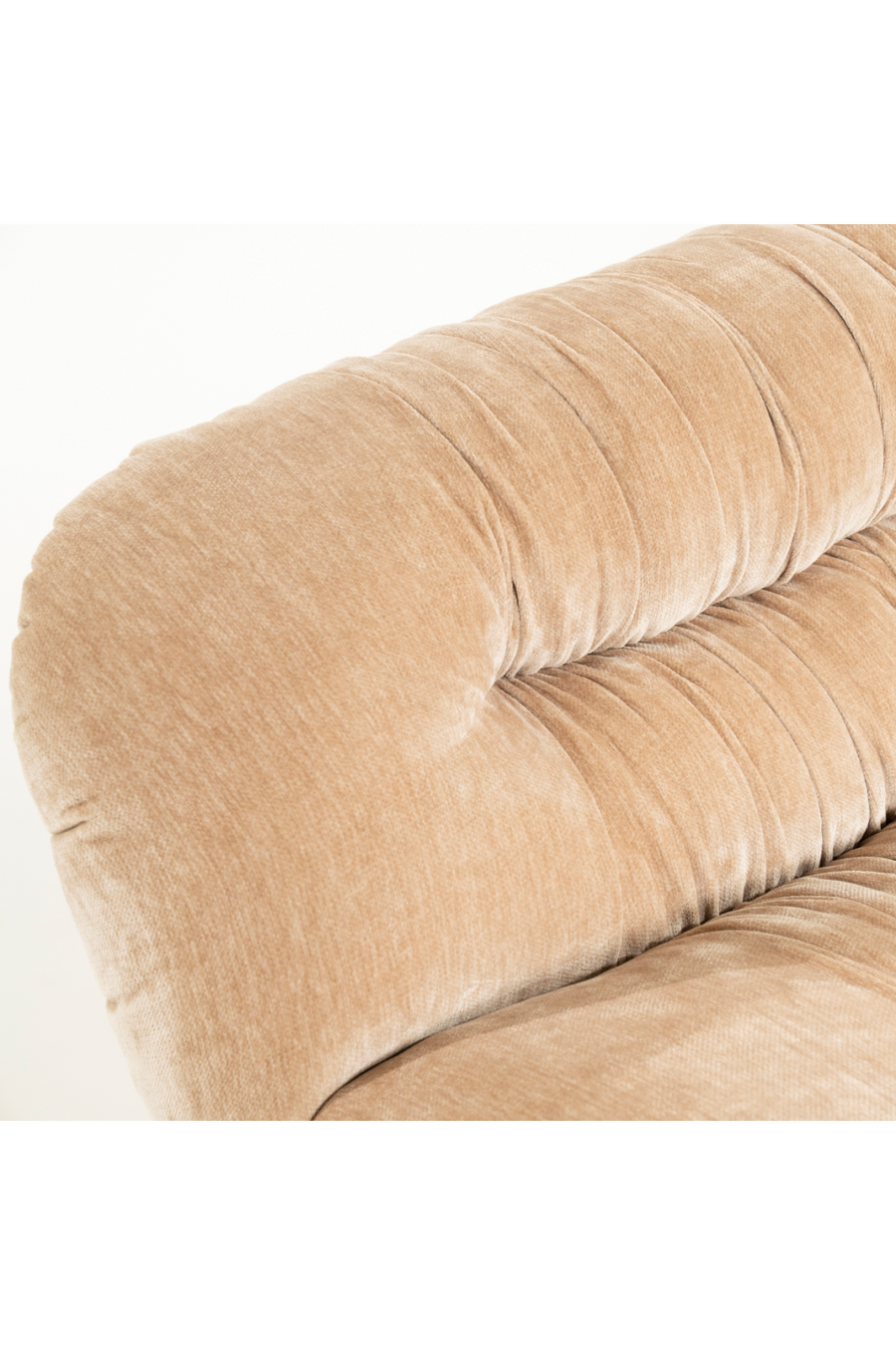 Close-up of beige velvet upholstery texture and tufts