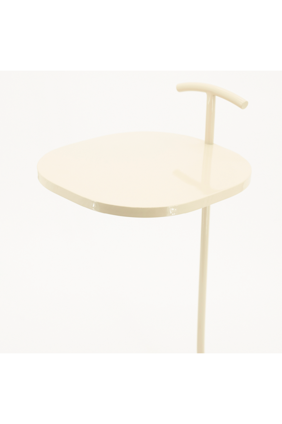 Close-up of lacquered beige round table top and stem