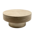 A modern round coffee table with a light beige wood-grain top and a brushed gold metal pedestal base.