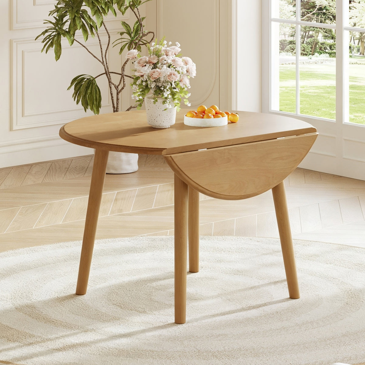 Natural Birch Veneer Round Drop-Leaf Dining Table — in a dining nook with one leaf lowered