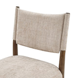 Upholstered dining chair with walnut-finish legs — curved backrest close-up