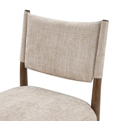 Upholstered dining chair with walnut-finish legs — curved backrest close-up