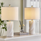 White Sculpted Ceramic Table Lamps — lit pair on a console