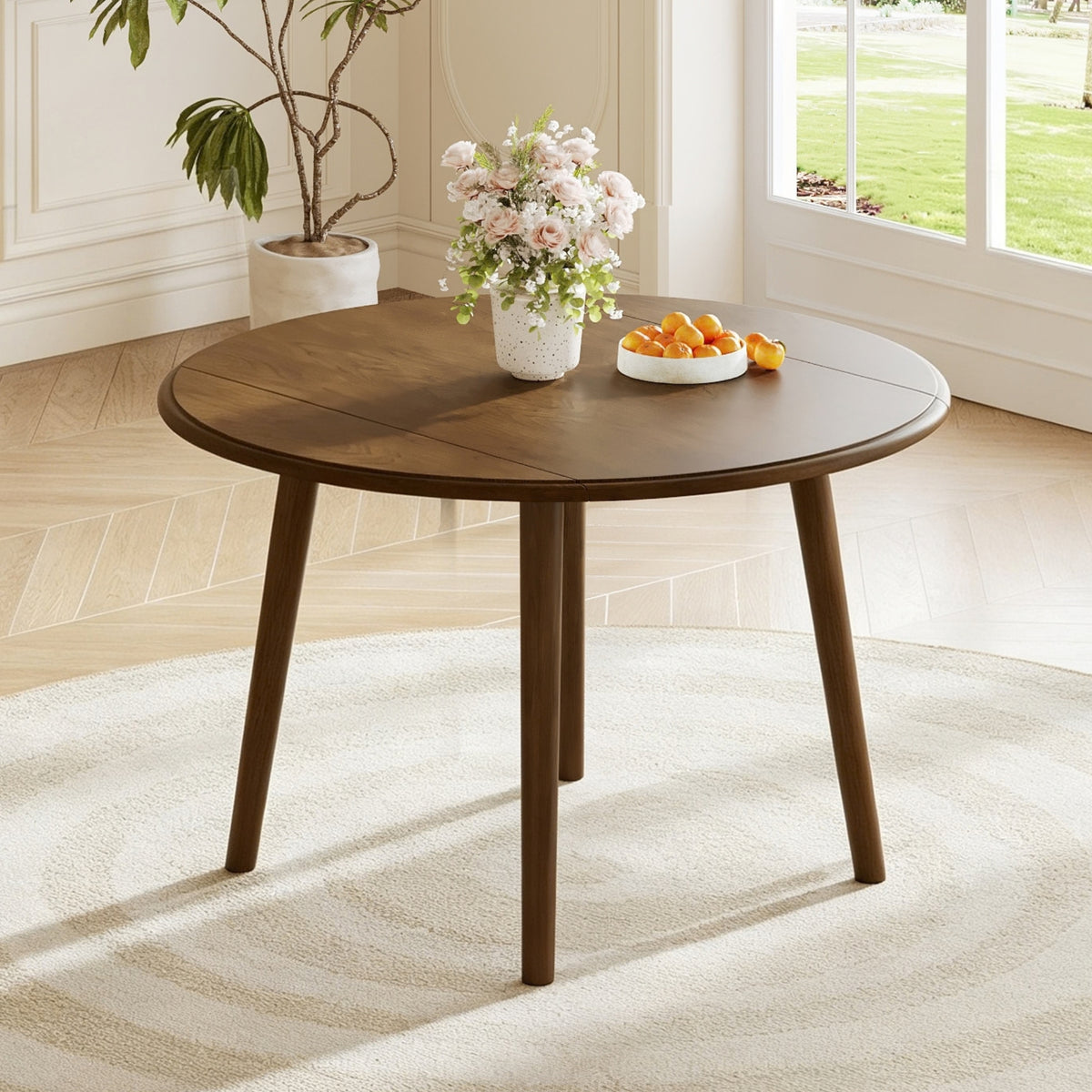 Walnut-Finish Birch Veneer Round Drop-Leaf Dining Table — in a dining nook with leaves raised