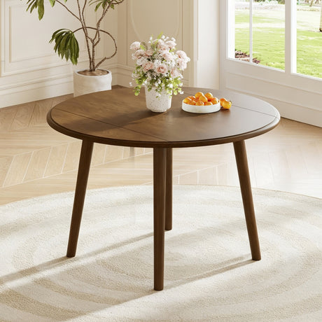Walnut-Finish Birch Veneer Round Drop-Leaf Dining Table — in a dining nook with leaves raised