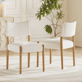 Cream Upholstered Natural Wood Dining Chairs — beside a dining table