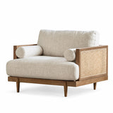 A mid-century modern accent chair with light beige textured upholstery, a natural wood frame, and a woven cane panel on the side- Maison naturelle on oroa.com