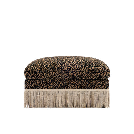 A square ottoman with a leopard print velvet top and a long fringe base, shown against a plain white background.