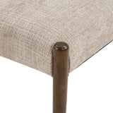 Upholstered dining chair with walnut-finish legs — seat cushion and leg close-up